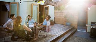 Friends sitting on a patio and chatting