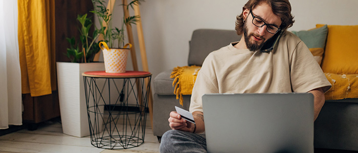 Concerned person on the phone with support before using his credit card online.